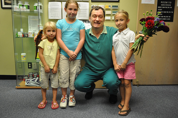 Dr. Borisenko receiving a bouquet from his patients